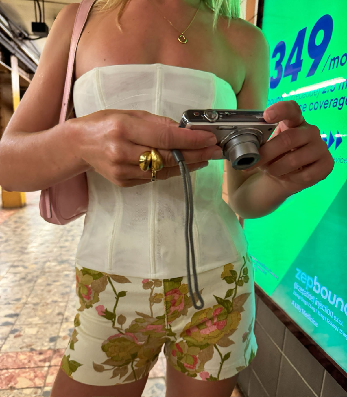 Person holding a camera with a blurred background nyc subway while wearing Jemma Ring