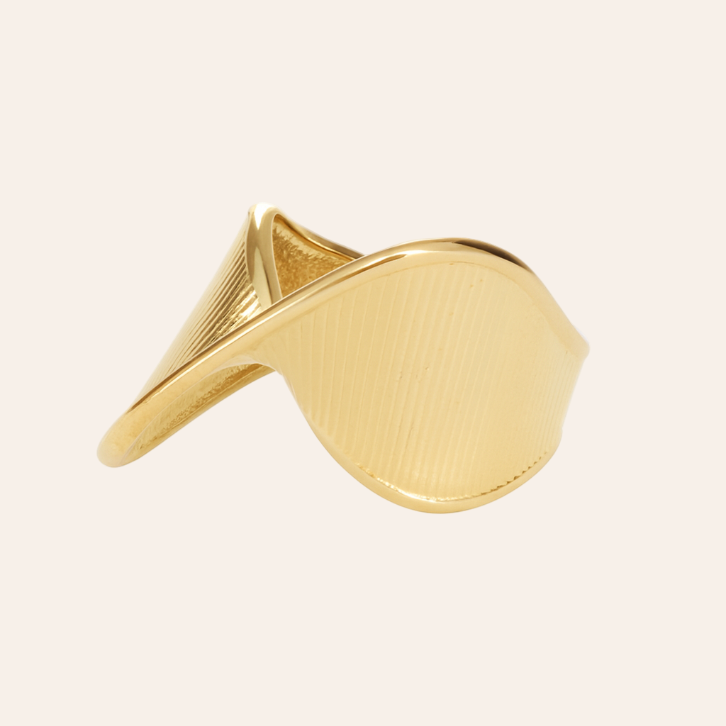 Gold ring with a unique design on a white background