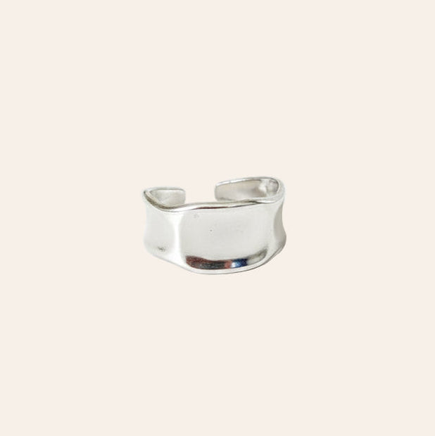 Silver ring on a light beige background