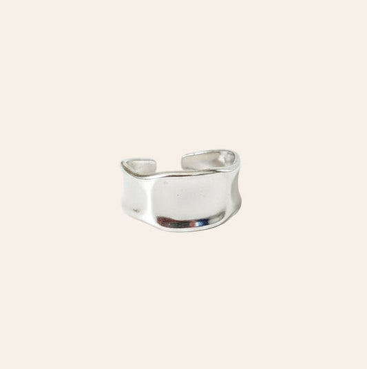 Silver ring on a light beige background