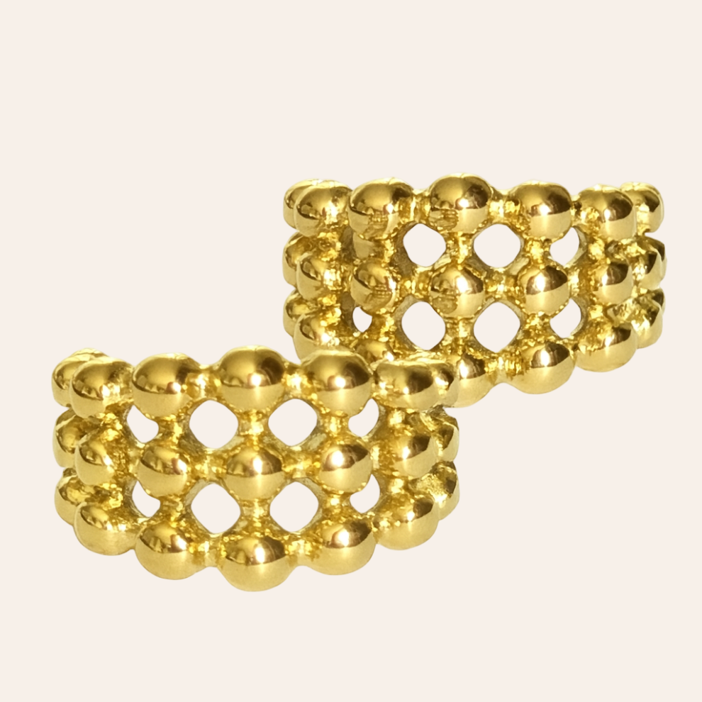 Gold lattice earrings on a beige background Vienna Earrings